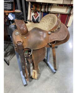 Used 15" Cactus rope saddle with tooled western floral detail in the worn, smooth leather. Comes with a wrapped horn, lighter tan seat color, and rope detail behind cantle.